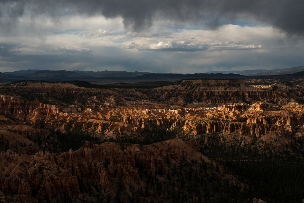 The last bit of sun pokes under the clouds to spotlight some of the hoodoos 