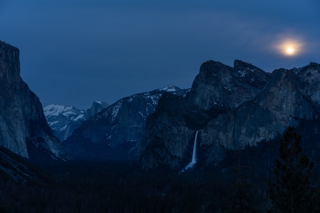 Moonrise behind the clouds over Bridalveil Falls